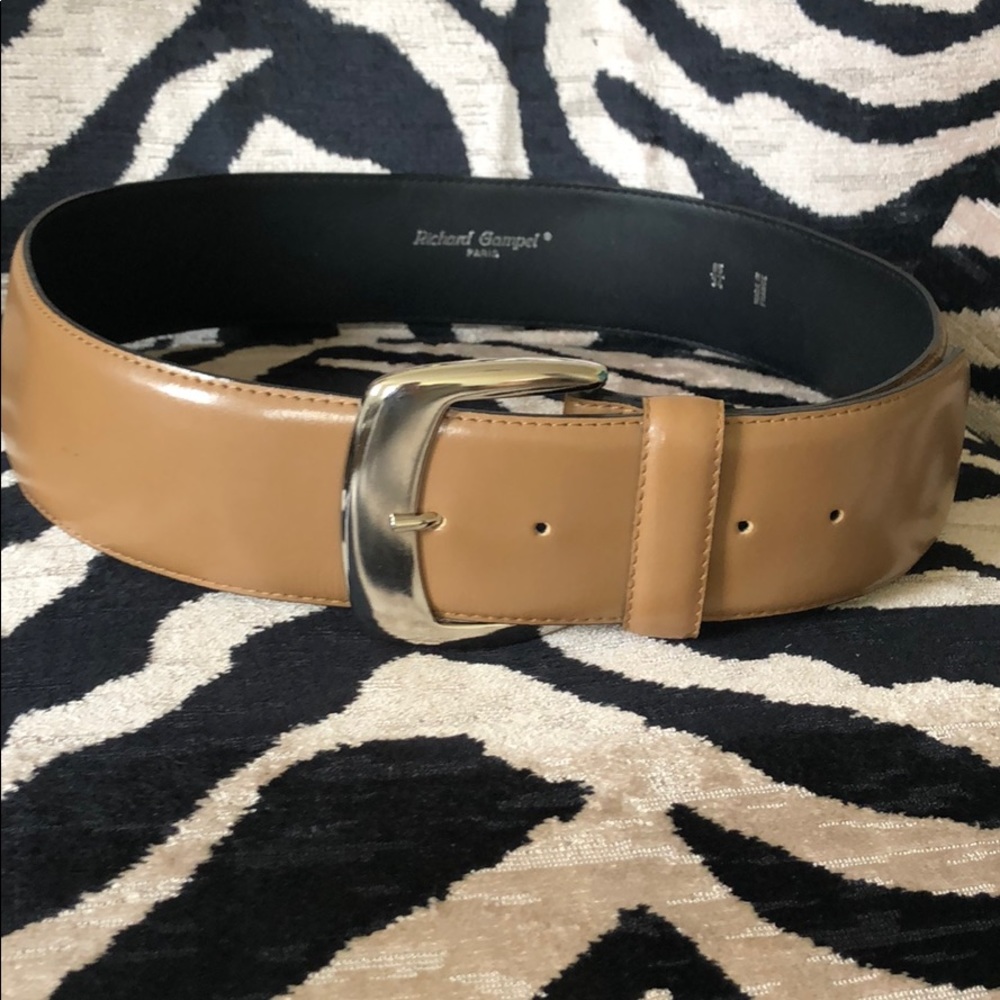 Tan leather belt with silver buckle.